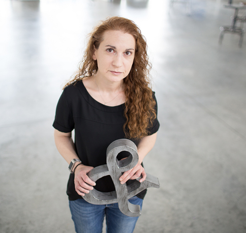 Color photograpgh from above of Monica Berlin holding an object